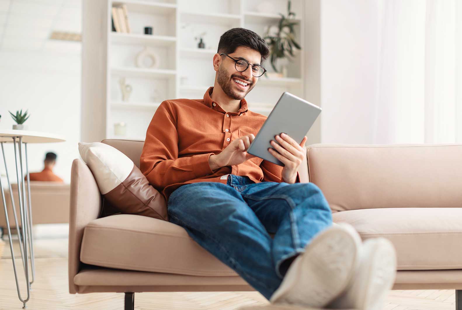 Man using tablet on couch