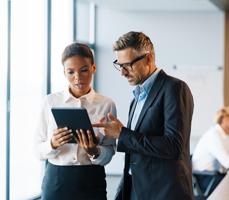 People working in office with a tablet